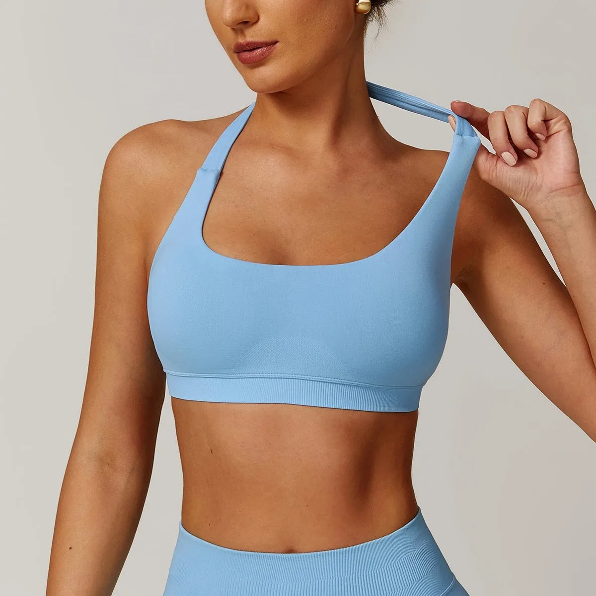 Women's black halter sports bra with medium support for yoga and workouts.