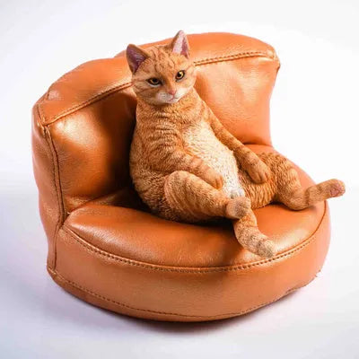 Lazy cat model ornament with sofa on car dashboard, 7.5cm high resin decoration.