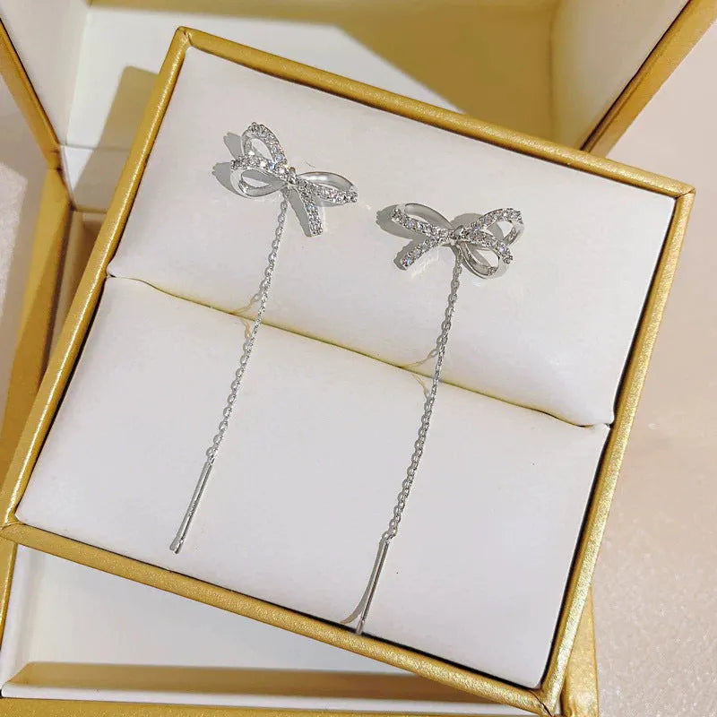 Women's white K bow earrings with long tassel ear thread, copper construction
