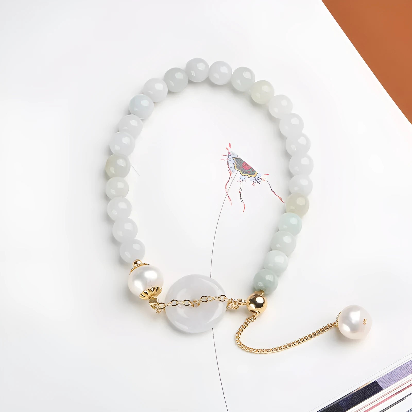 Natural jade bracelet with peace buckle fastener and white pearl accents, geometric pendant design