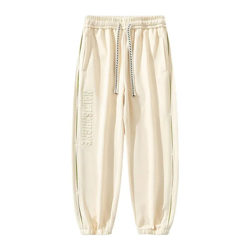 Men's loose fit cotton casual trousers with stitching print design and banded ankle cuffs.