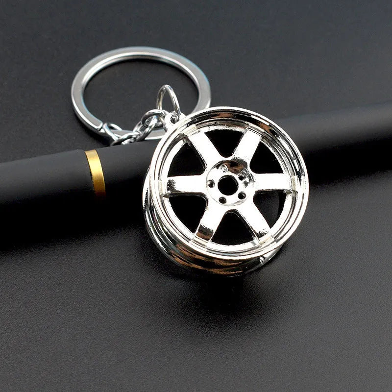 Zinc alloy wheel hub car keychain in gold, silver and gun black colour options