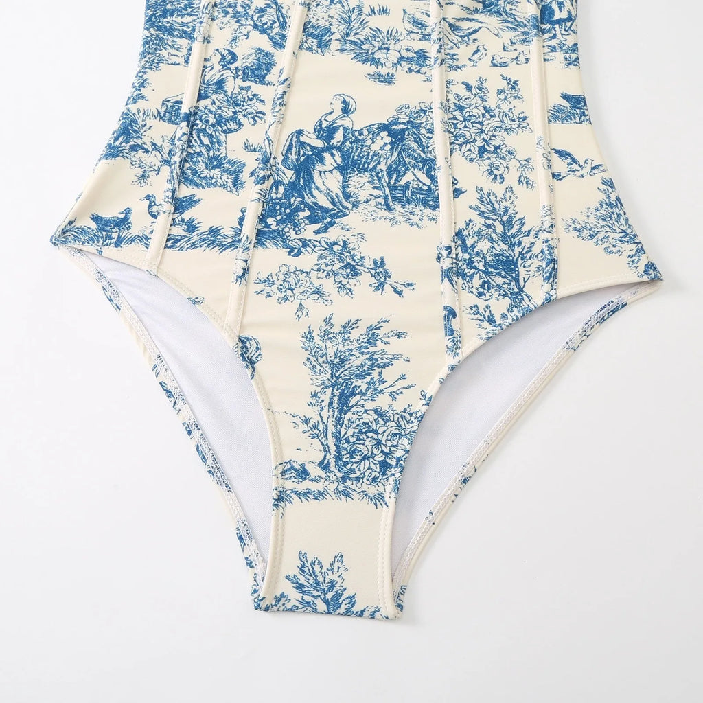 Blue patterned women's one-piece swimsuit shown with a matching light gauze skirt.
