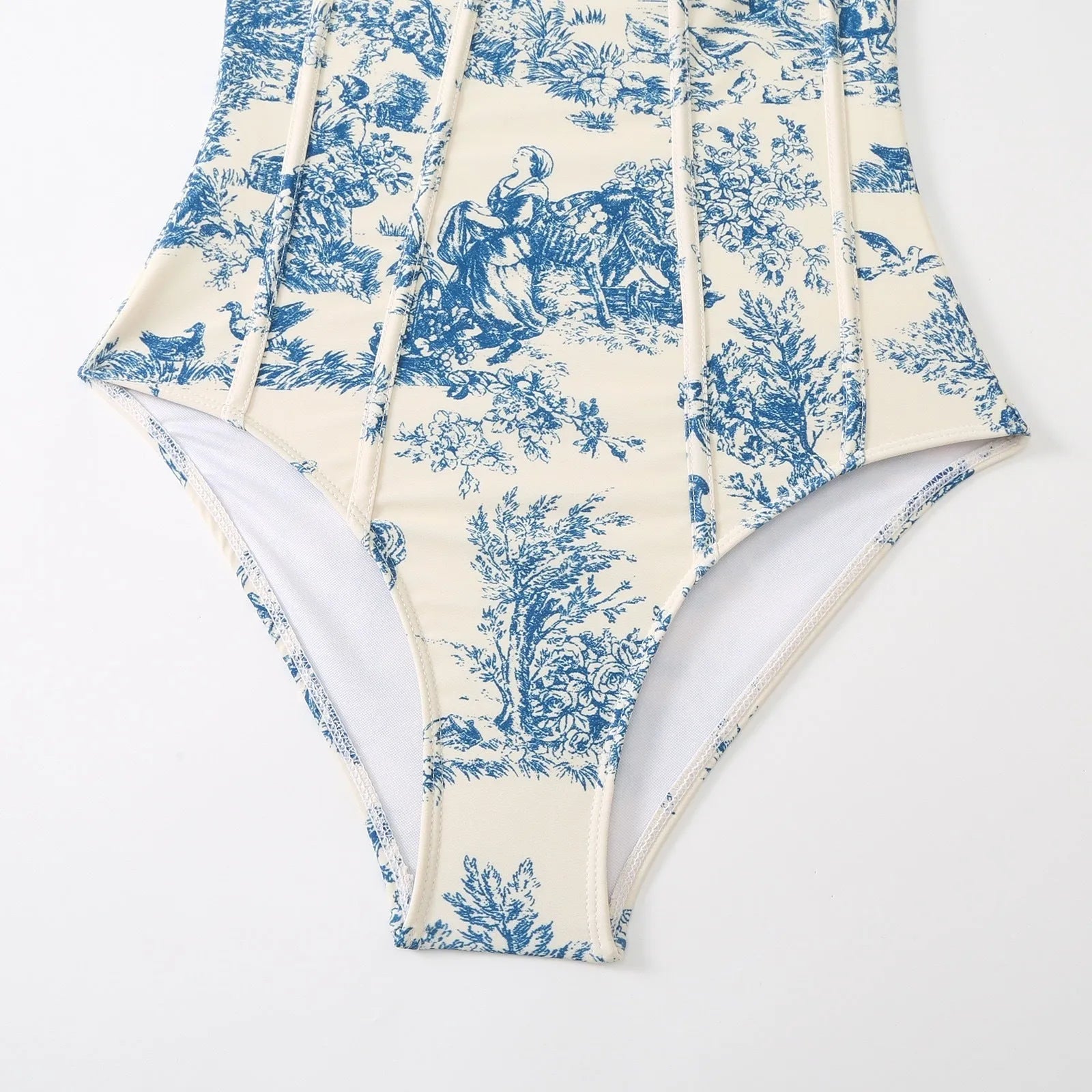 Blue patterned women's one-piece swimsuit shown with a matching light gauze skirt.