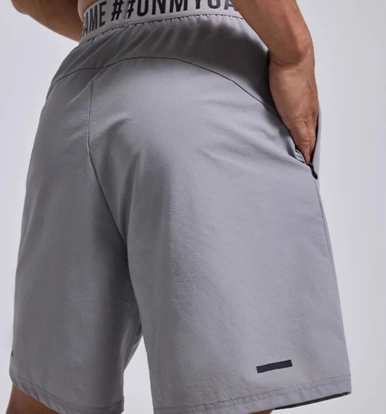 Men's loose black sports shorts with elastic waist and letters detail, laid flat.