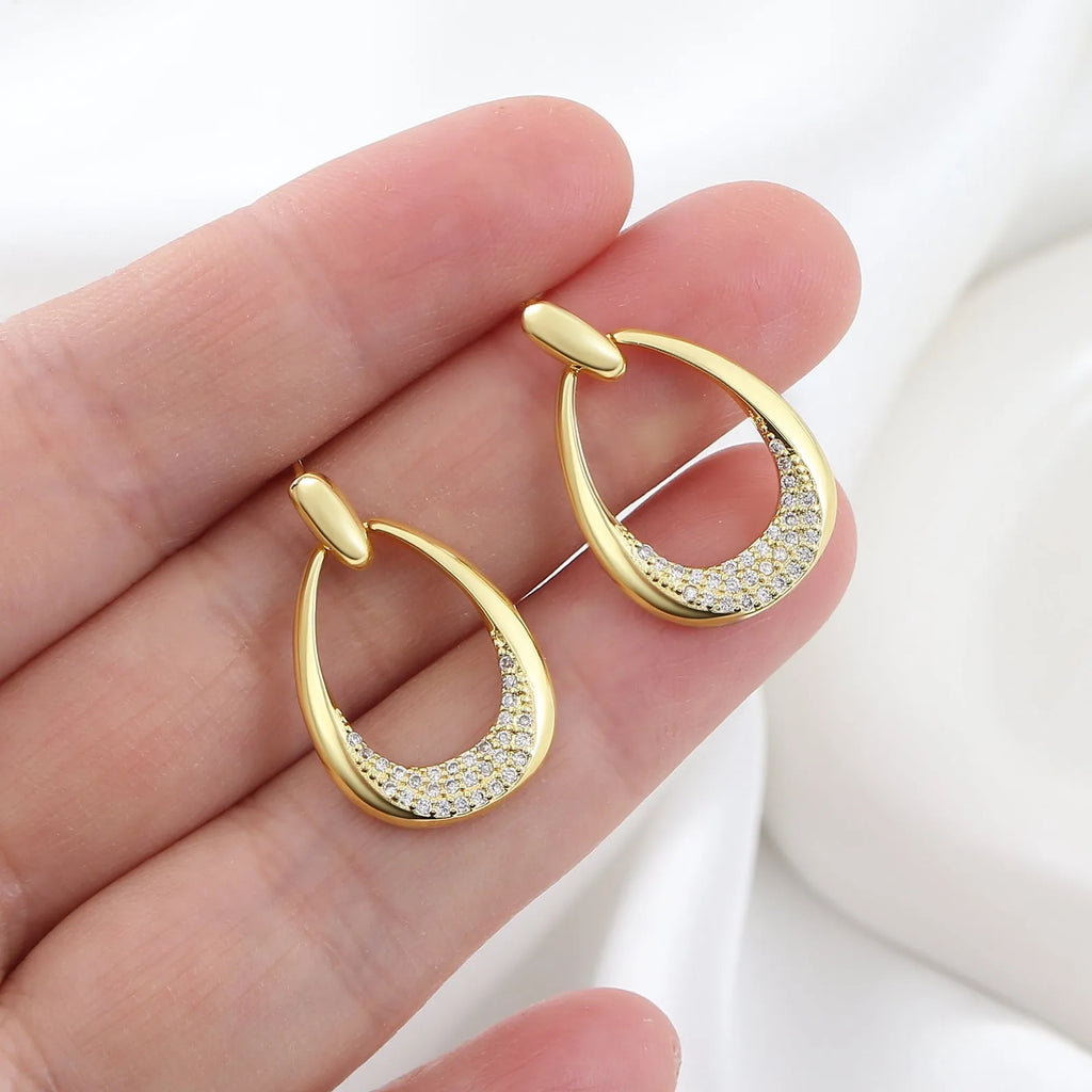 Women's geometric drop earrings with zircon details and yellow gold electroplated finish measuring 2.6 by 1.7 cm