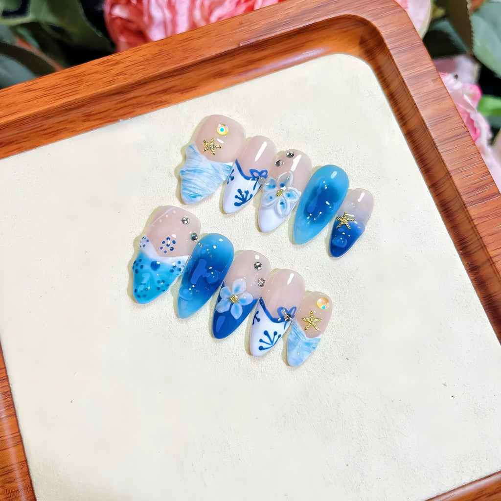 Blue hand-painted carved false nails on transparent summer base with XS, S, M, L size options