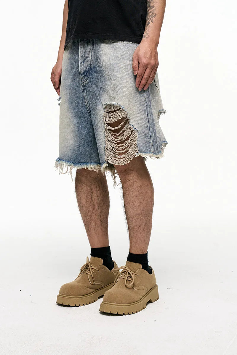 Light blue men's baggy denim shorts with a wide leg and retro washed finish on a mid waist.