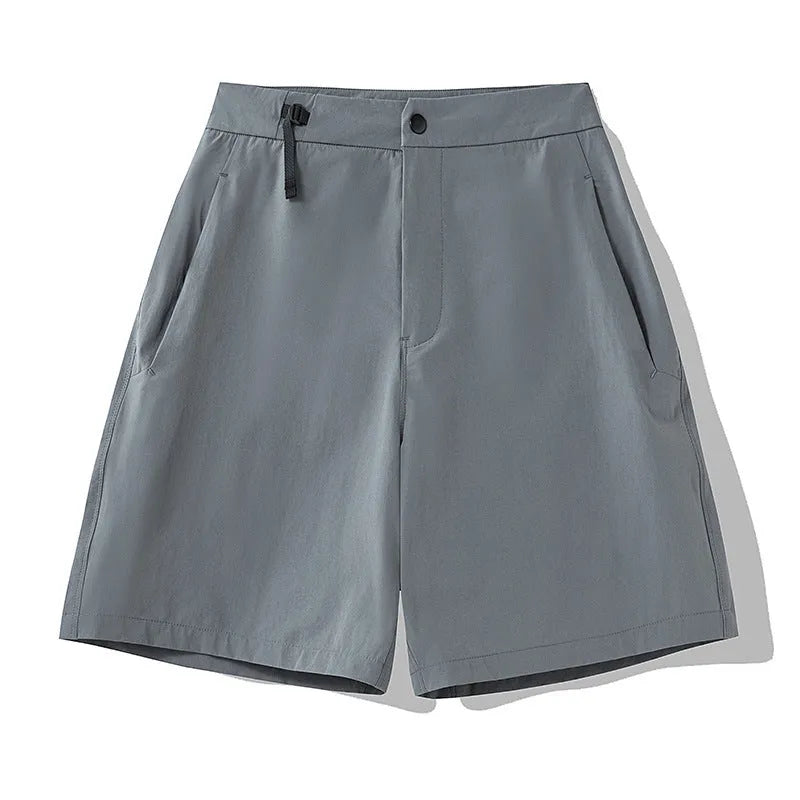 Men's solid colour quick-dry sports shorts with elastic sides on a neutral background.