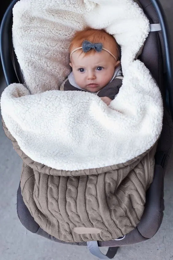 Envelope-style baby stroller sleeping bag in a choice of colours with cotton wool filling.