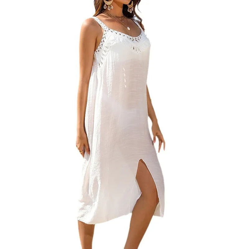 White crochet beach dress with hollow weave and bottom slit on a model.