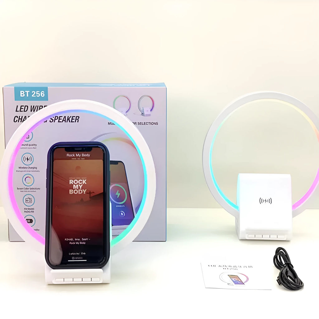 White rectangular smart Bluetooth speaker with integrated wireless charging pad and ambient light on a desk