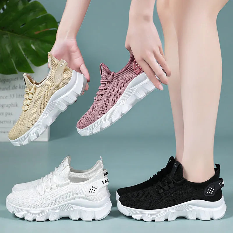 Women's white Flyknit sneakers with round toe and flat heel on a thick PVC sole.