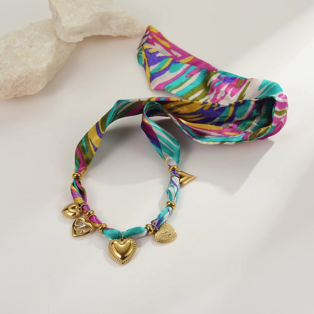 Gold geometric pendant necklace and bracelet set with adjustable chain on white background