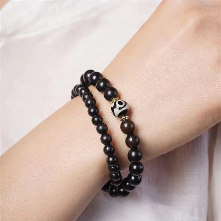 Ebony wood bracelet with 8mm beads showing two circles pattern, unisex design