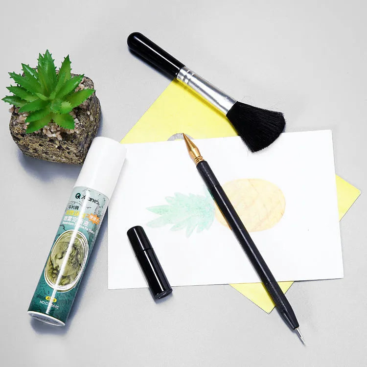 Scratch painting tool set with healing pens, brushes, scrapers, and photo frames on white card paper