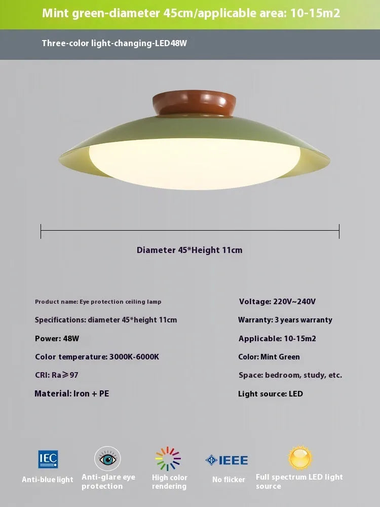 Modern minimalist cream style flying saucer ceiling lamp in mint green on a white ceiling.