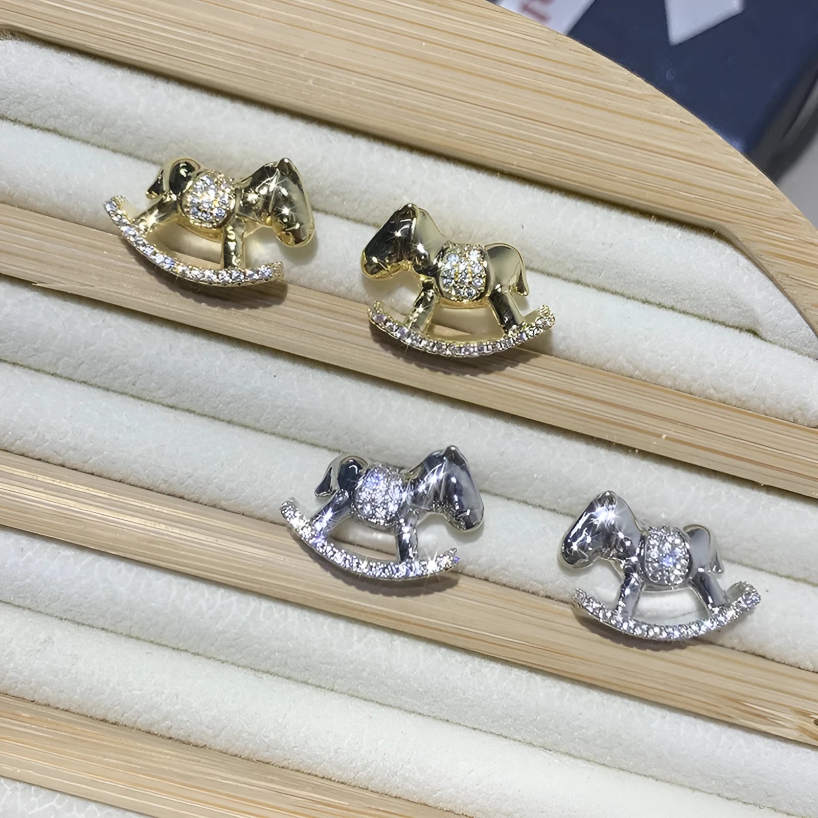 Diamond studded women's light luxury rocking horse drop earrings in gold colour on display