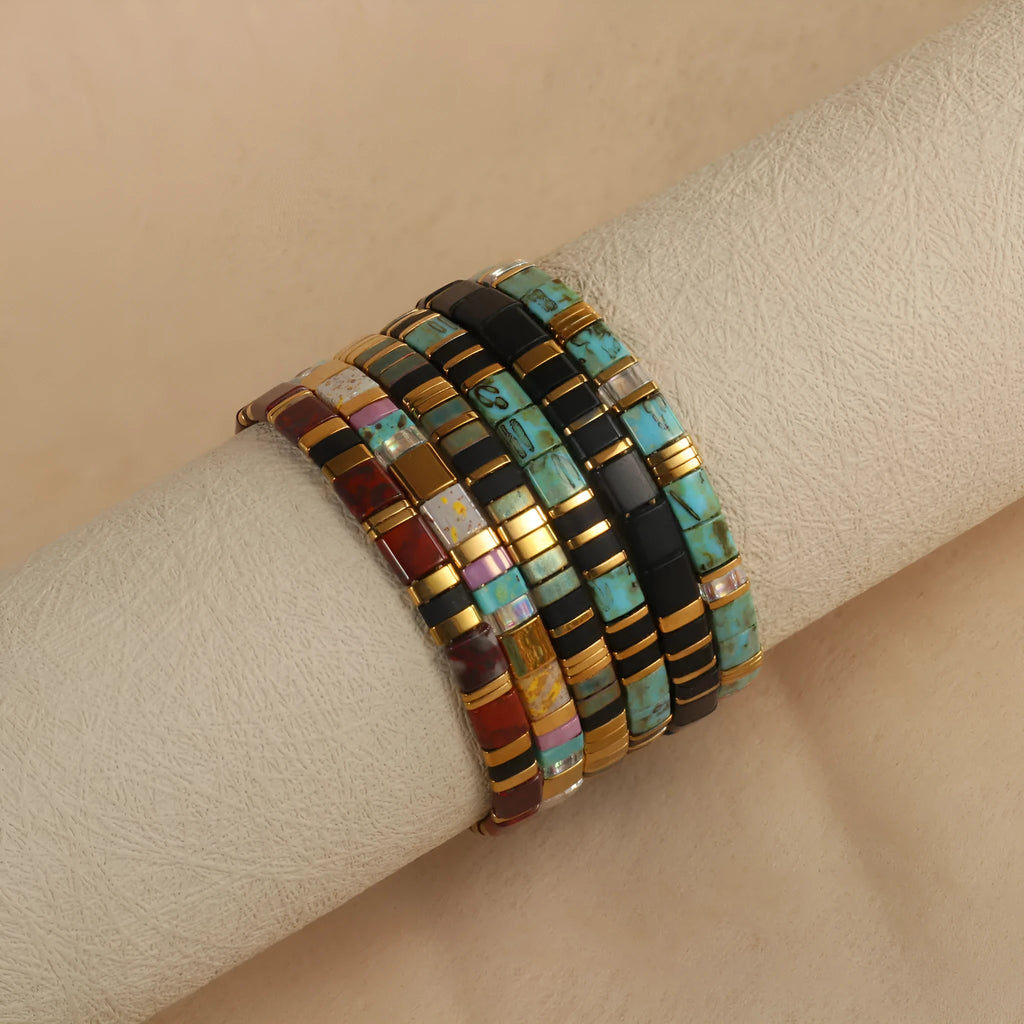 Geometric round glass bead bracelet in milky white, black, green, blue, or red.