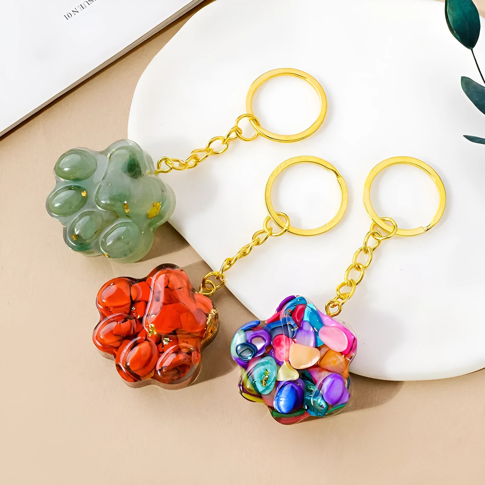 Small natural crystal cat's paw claw charm on a metal loop keychain