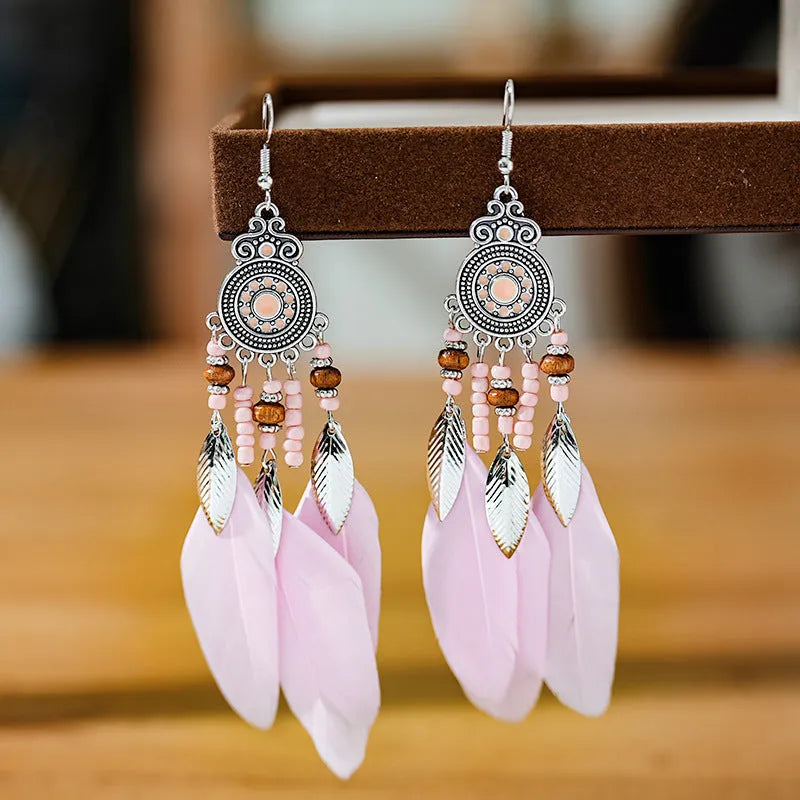 Round drop feather earrings with leaf patterning in alloy, available in multiple electroplated colours.