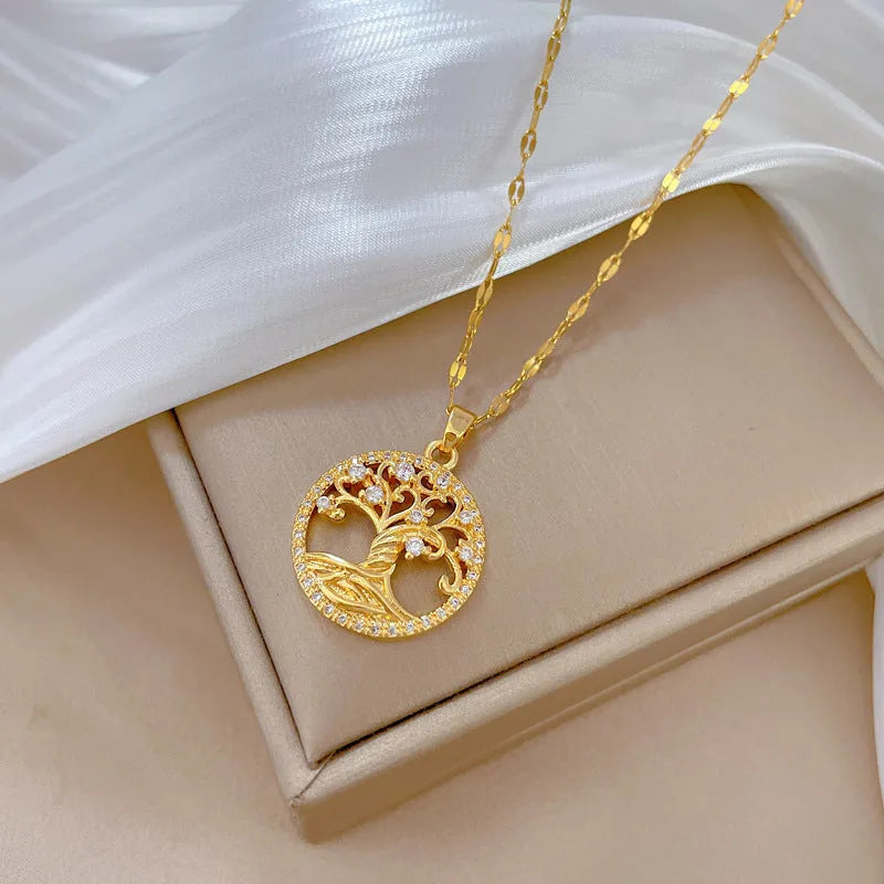 Gold-plated adjustable necklace with cross pendant showing mother of pearl inlay and rhinestone lucky tree design