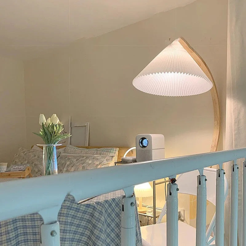 Vertical retro floor lamp with wood shade in three-colour variable light beside bed