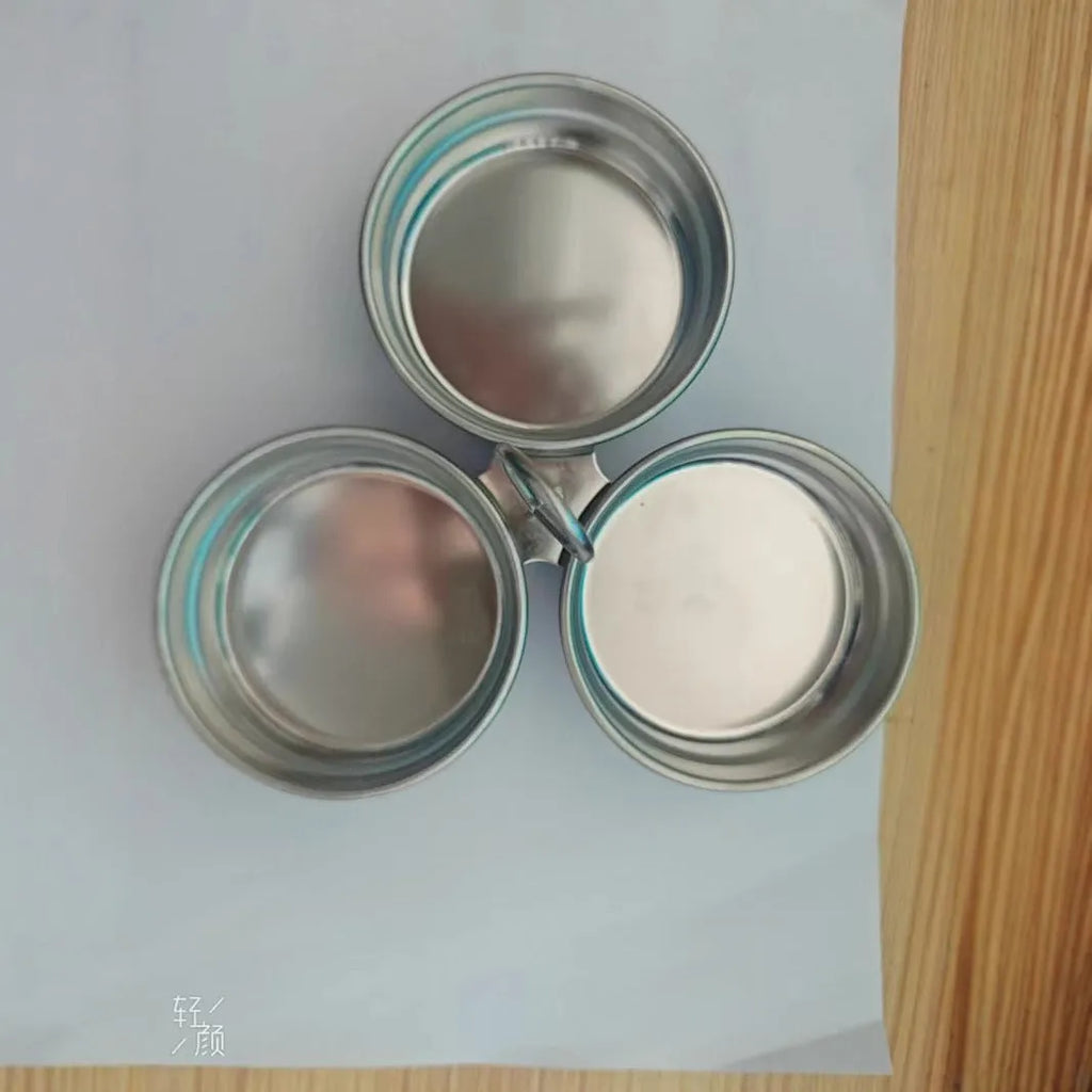 Mini stainless steel egg steamer showing both round and heart-shaped design options on a kitchen counter.