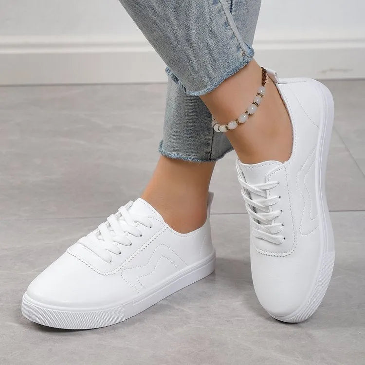 White round toe lace up casual shoes with platform heel on a flat surface