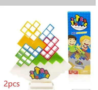 Plastic balance stacking board game with 16 coloured building blocks, chassis, and base on table.