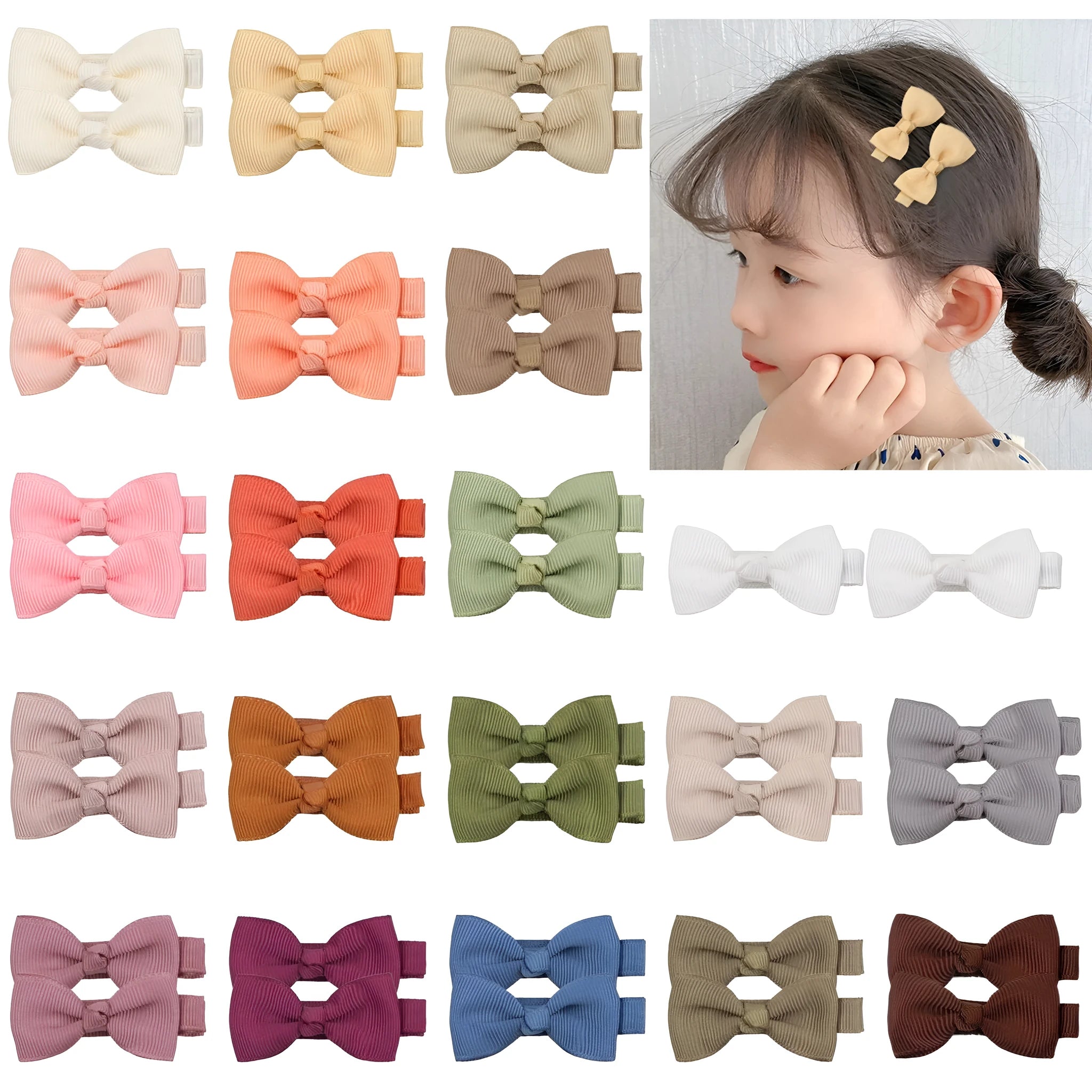 Assortment of pastel-coloured bow and barrette hair clips for babies on a white background.