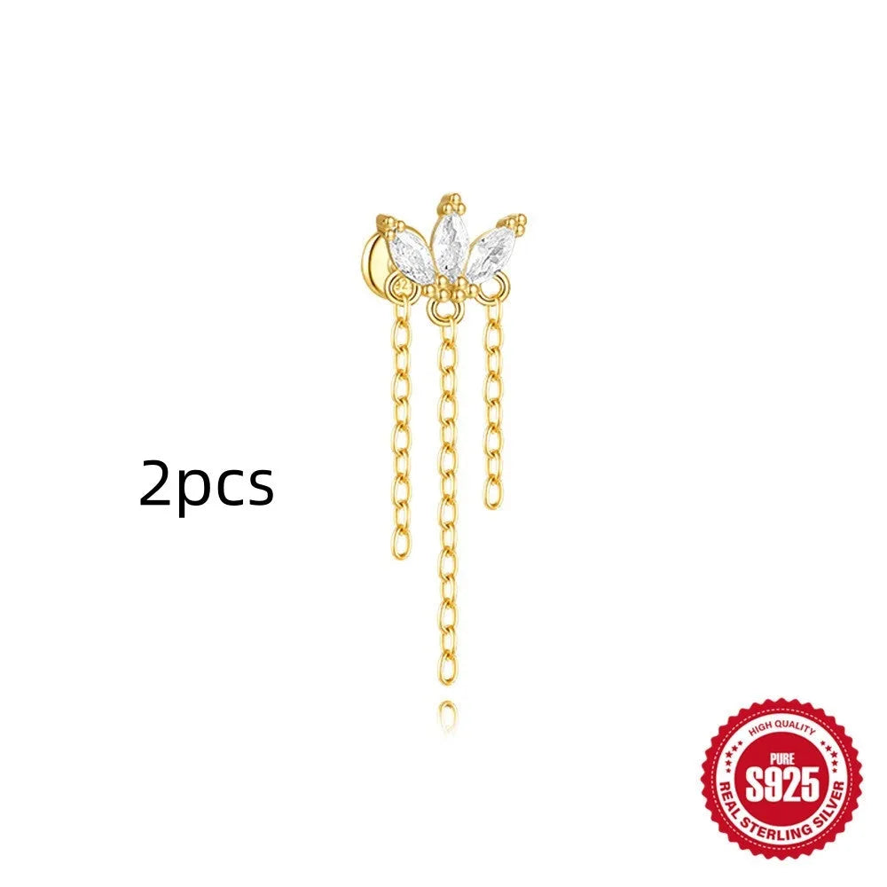 Geometric kite-shaped sterling silver stud earrings with rhinestones and a gold chain tassel.