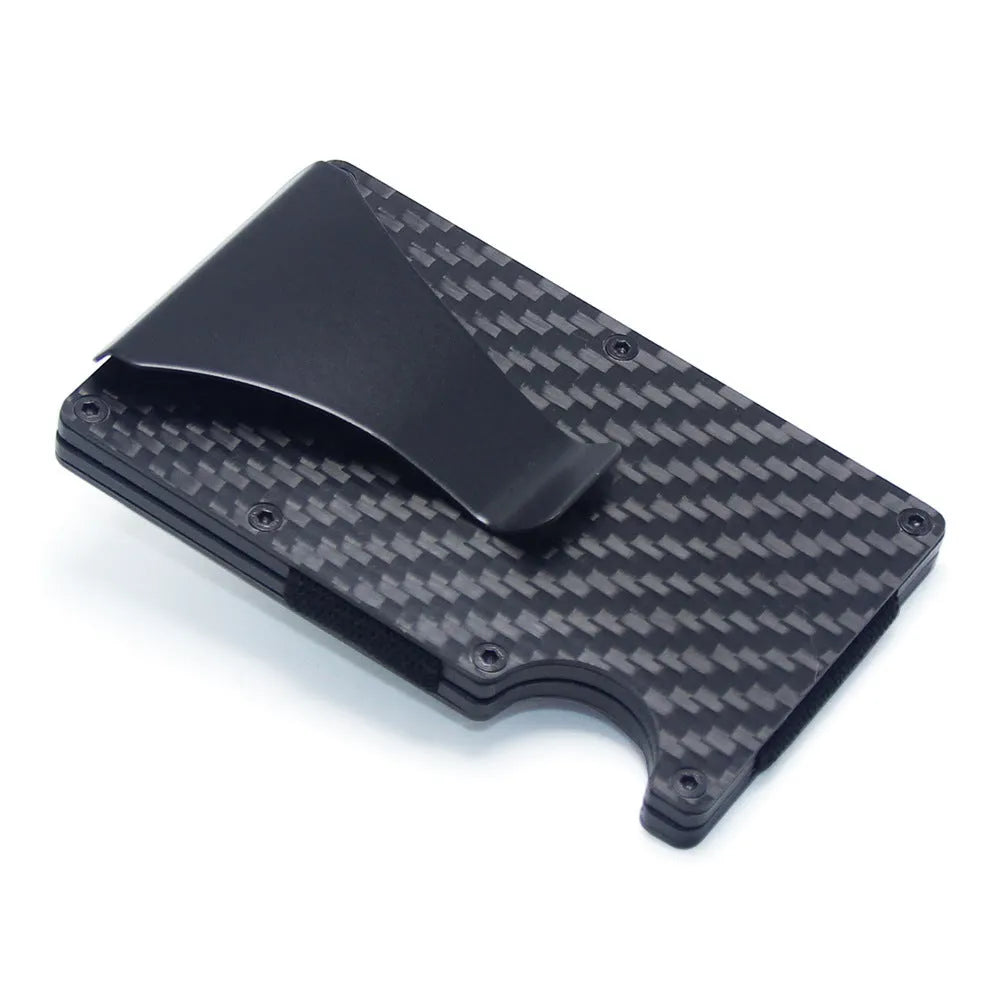 Slim black carbon fibre card holder wallet with geometric design on a table.