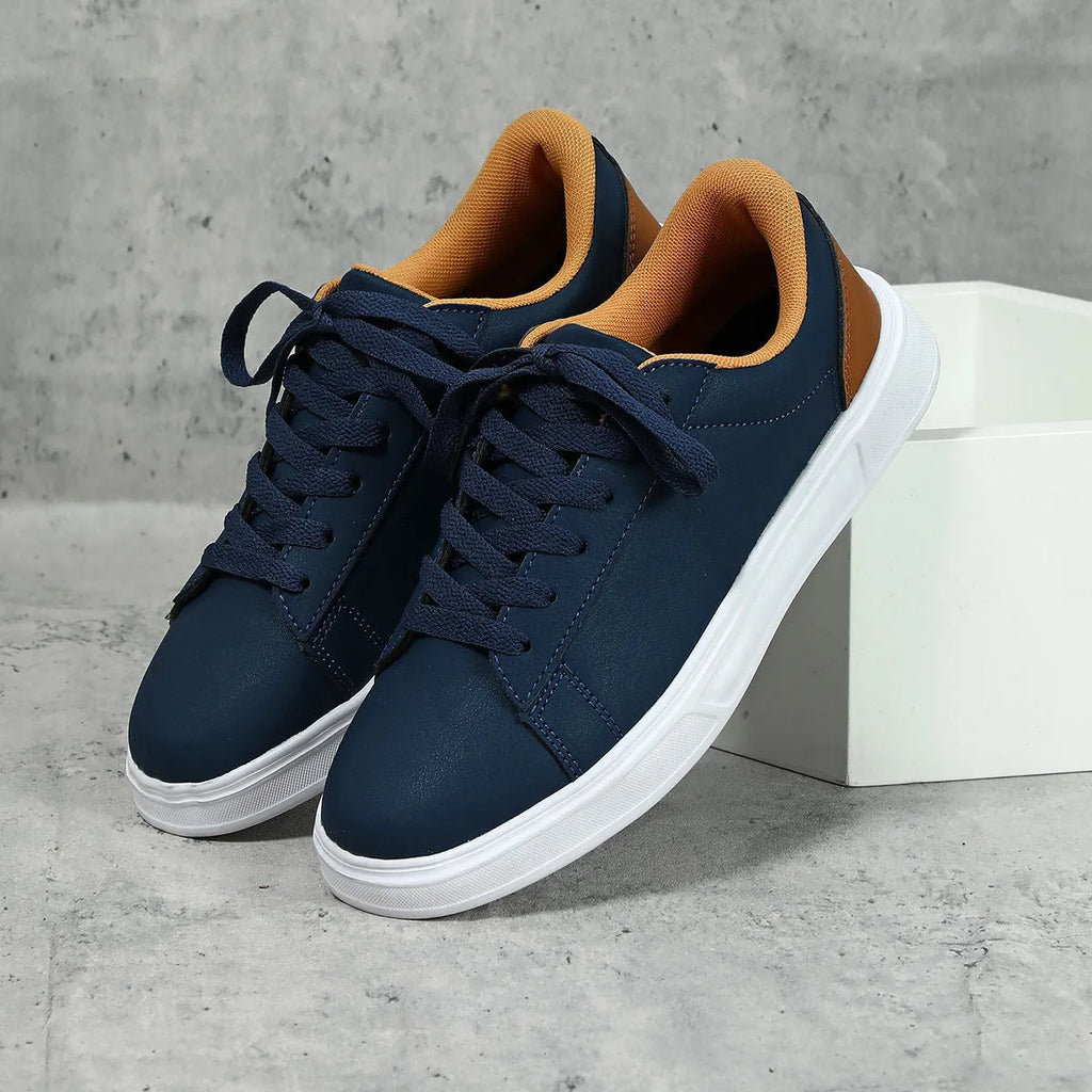 Casual beige brown platform sneakers with a cross strap and round toe on a flat rubber sole.