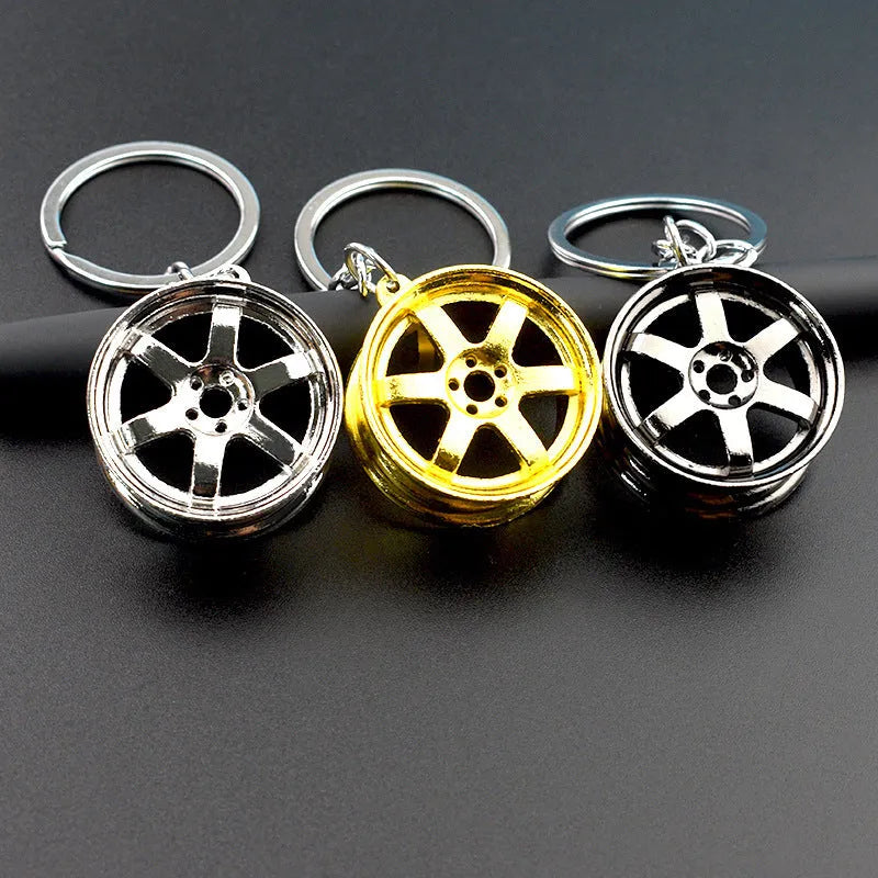 Zinc alloy wheel hub car keychain in gold, silver and gun black colour options