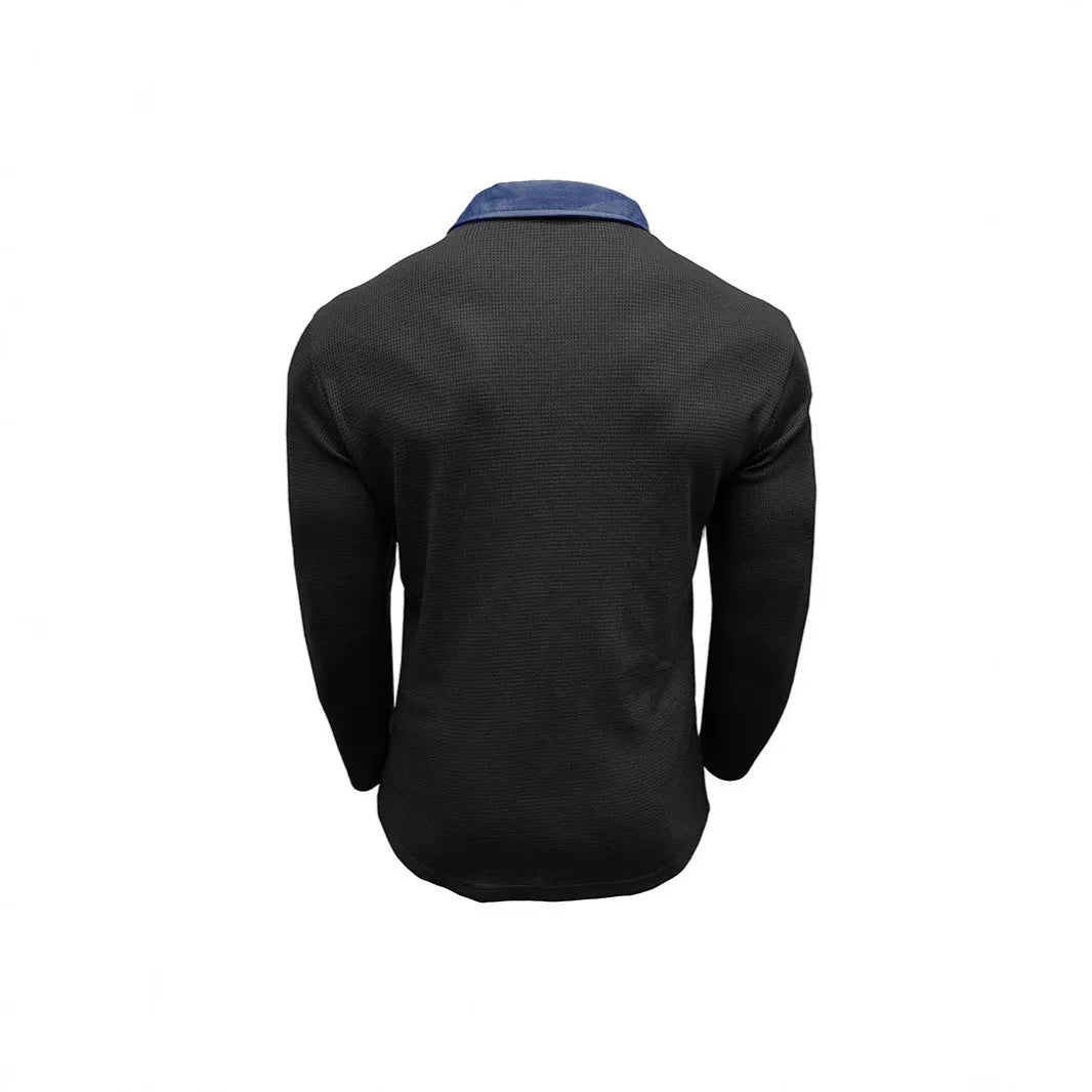 Man wearing a long-sleeved waffle-texture polo shirt in a solid colour with a loose, retro fit.