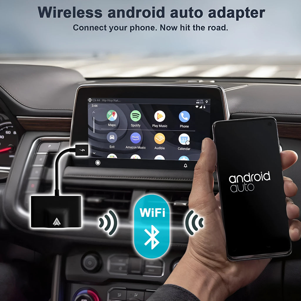 Black wireless Android Auto car adaptor connected to a car USB port with a smartphone displaying a navigation app wirelessly.