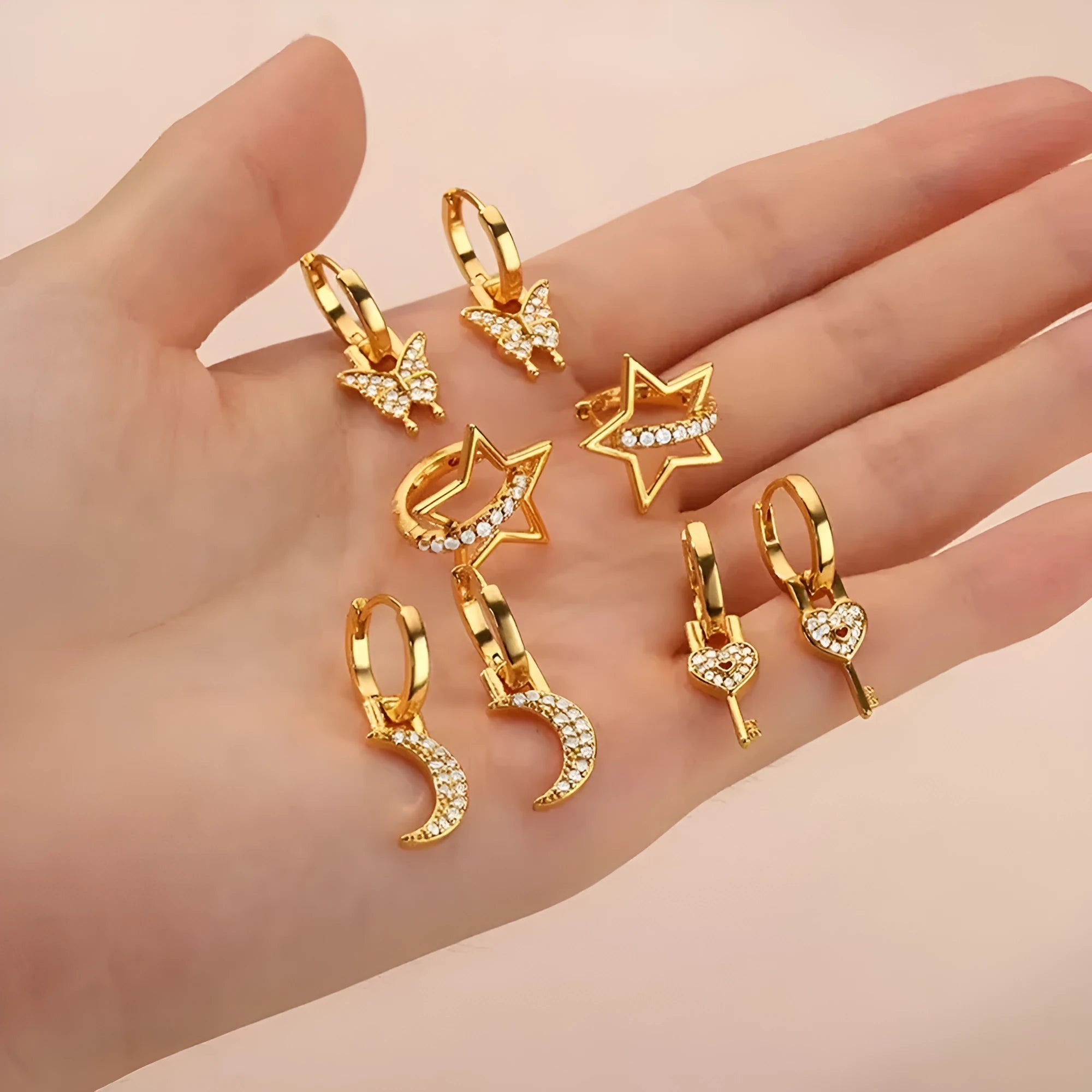 Geometric copper butterfly earrings with a heart, bow, and star details in a selection of colour finishes.