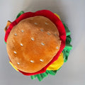 Cat wearing a soft plush burger headdress collar with an adjustable elastic strap