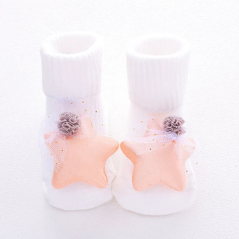 Cotton baby socks in multiple colours and prints including panda, lion, bows, and stars on a white background.
