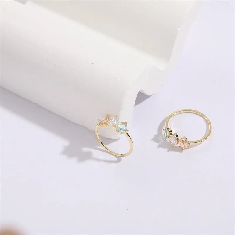 Geometric triangle ring with horse eye design and tricolour zircon stones in gold electroplated finish