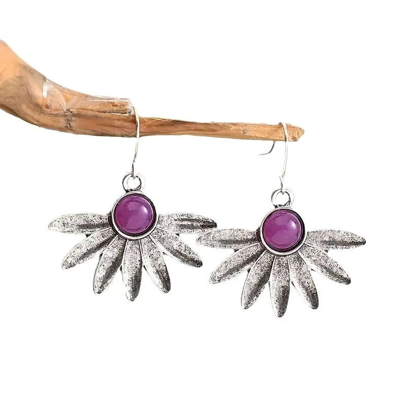 Purple resin Bohemian earrings with animal zodiac design on alloy metalwork.