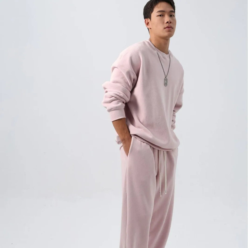 Men's polar fleece tracksuit set showing crew neck top with padded trousers in winter sportswear style