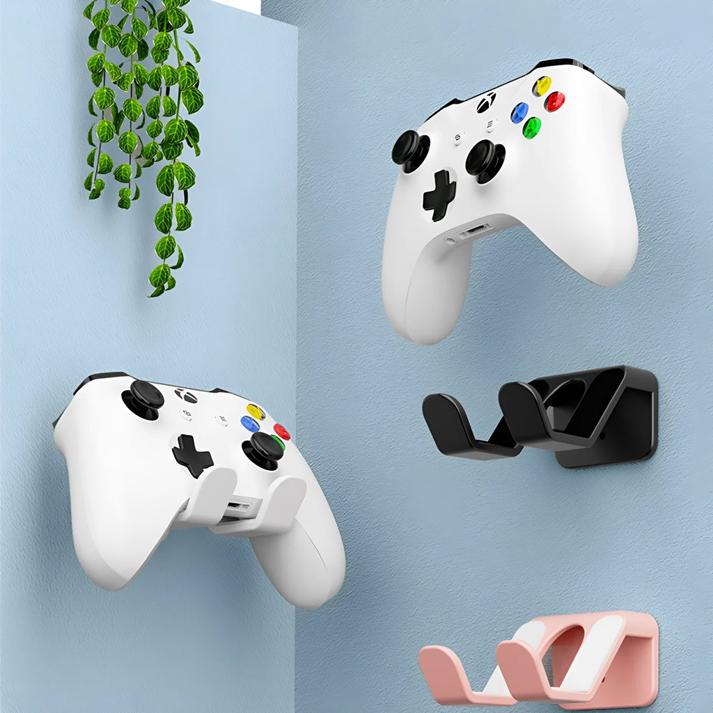 Black universal hanging rack with X-handle design mounted on a wall next to game controllers.