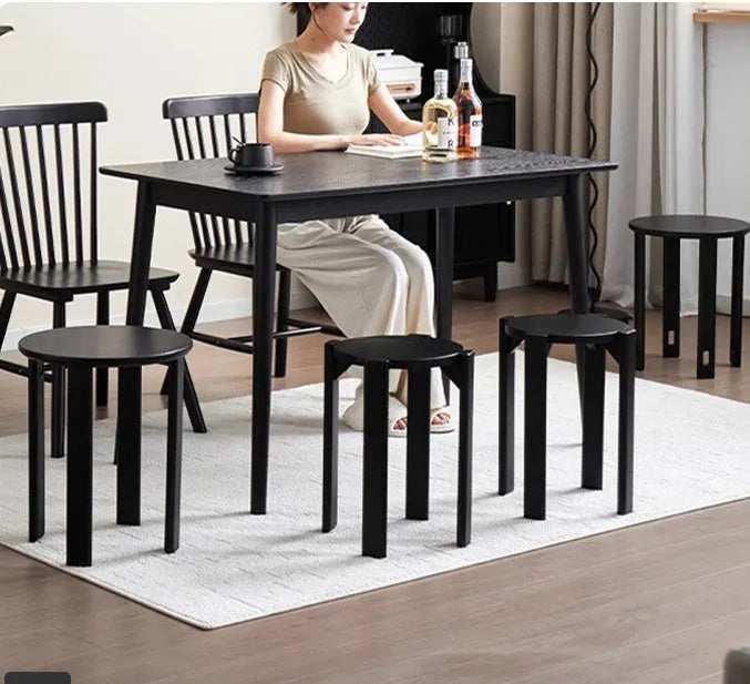 Stackable round iron dining stool in a modern style, shown in a choice of colours.