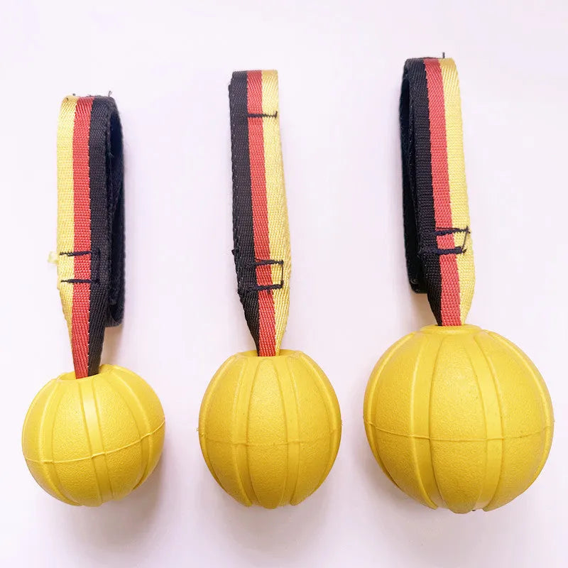 Yellow and camouflage coloured EVA foam floating dog tether balls in three different sizes on a blue background.