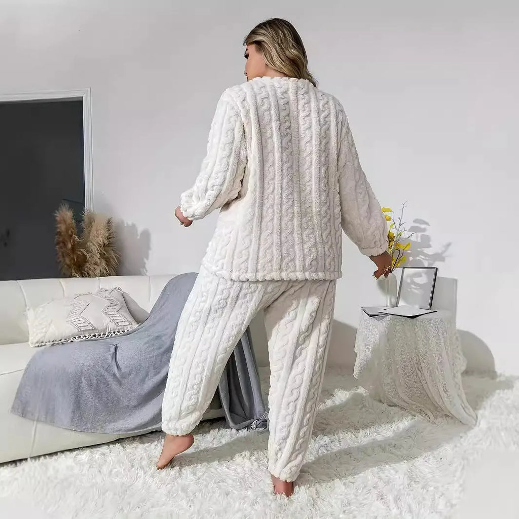 Creamy white women's long sleeve crew neck top and trouser set on a hanger.