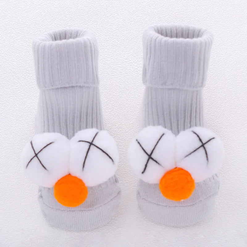 Cotton baby socks in multiple colours and prints including panda, lion, bows, and stars on a white background.