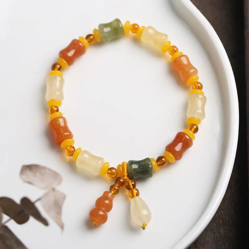 Jinsi Jade bracelet with small bone beads showing auspicious patterns and geometric design