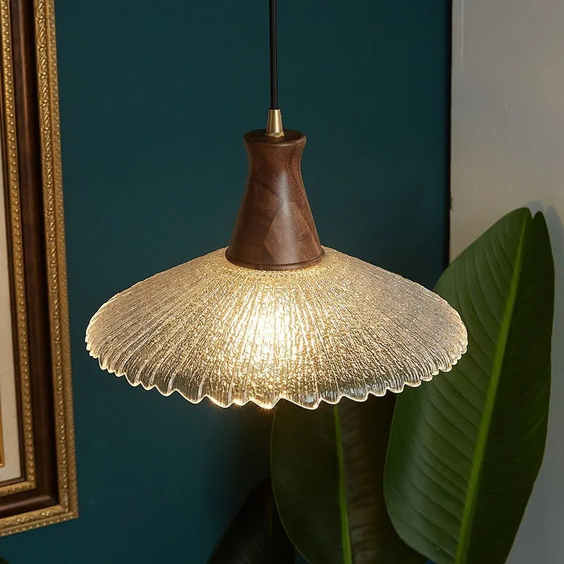 Wood and brass ceiling chandelier with glass lampshade in three available sizes.